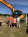 (L-R): Matt Mixon of Performance Farms, Orangeburg, S.C., and Patricia and Wendell Kaminer of Wendell’s Hay Farm, Gilbert, S.C., take a look at a Hyundai HX 140L excavator. 
