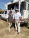 Joey Martin (L) and Jason Stribling, both of Joey Martin Auctioneers, greet auction guests in front of their trailer. 

