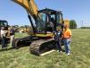 Travis Anderson (L) and Chuck Sullivan, both of AMC Materials in Jefferson, N.C., survey the excavators at the event. 
