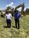 Stuart Brown (L) and Dennis Brantley, both of McGee Brothers in Monroe, N.C., keep an eye out for machines they could add to their current fleet. 
