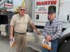 Bob Hughes (L) of Century Truck & Trailer Sales and Jerry Smith of CJ Motors review the equipment in the yard.
