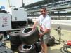 Mike Myslicki of Sennebogen gets a feel for the weight of the tires while touring the pit area for Car #15, driven by Graham Rahal. 
