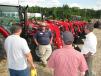 AGCO’s Bill Hardy (C) highlights the features of the Massey Ferguson tractors available at The Thompson Cat Rental Store.