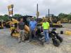 (L-R): Will Wood of Carolina Cat answers some questions about this Cat 289D track loader for Neil Couch and Erasmo Cortez, both of Erosion Control in Monroe, N.C. 
