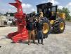 Alvin McNeill (L) of T.H. Blue Inc. in Eagle Springs, N.C. and Charlie Orr of Carolina Cat, stand in front of a Cat 563D feller buncher with a Cat HFW221 cutting head. 