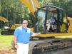 Blanchard Machinery’s technology manager, Brett Rutland (L), provides information while Bob Sharpe operates the new Cat 320 excavator, demonstrating how to utilize the newest excavator technology. 