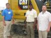 (L-R): Blanchard’s Scott Hill talks with Trev Howard and Darrin Sheriff, both of Palmetto Corp. in Conway, S.C., about Palmetto Corp’s recent purchase of the Next Generation Cat 320.
 