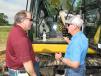 Todd Phillips (L) of Gulfstream Construction in Mt. Pleasant, S.C., and Blanchard Machinery’s Bob Sharpe discuss the operational advantages of the new Cat 320 hydraulic excavator. 
 