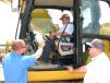 Blanchard Machinery’s Brian Hutchison (L) provides a personalized demo of the all-new Cat 323 hydraulic excavator to Chris Matthews (in cab) and Jay Matthews, both of Matthews Construction in Rock Hill, S.C.
 