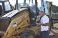 Bruce Yager, president of Yager Maintenance in Somerset, N.J., checks out a Cat backhoe. 