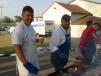 Nick Stipanovich (L) and Adam Salinas, both of Illinois Truck & Equipment, help with cooking the steaks. 