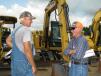 Jim Bennett (L), retired contractor from Picayune, Miss., and Herb Haddox, Haddox Blueberry Farm, Sumrall, Miss., discuss the lineup of machines in the sale. 