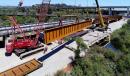 Crews place the 11-ft. deep steel girders spanning the San Diego River. 