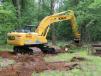 Wayne King Sr. pulls stumps with a Kobelco SK210LC excavator from Harter Equipment. 