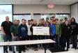 Port Washington High School students pose with a large check from Telsmith Inc. 