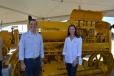 Peter J. Holt, CEO and general manager, and Corinna Holt Richter, president, both of HOLT CAT, stand in front of a 1932 Caterpillar Gas 65. 