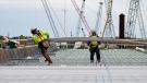 Workers lay the westbound deck along the Moline riverfront. 
(© 2019 Iowa DOT)
 