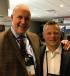 Ruffridge-Johnson设备有限公司有限公司首席执行官乔恩Pederson(左)和总裁Dave Hosch迎接客人在最近AED峰会在奥兰多。