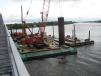 Equipment used in the project includes a Manitowoc 2250 crane and an assortment of barges. 
 