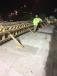 Workers shore up the new concrete bridge railing. At this point, the replacement is two nights away from completion.
(Tennessee DOT photo) 