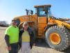 Jim Farrell (L), machine operator of Kohler Pit Inc., and Mary Gumieny Bultman, controller at New Berlin Redi-Mix, take time out from their busy work schedules to pose with the Hyundai HL 960 wheel loader.
