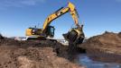 A Cat 320D with MB-S18 tackles environmental remediation in Argentina. 
