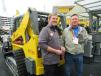 Hank Fredrickson (L) of Wacker Neuson answers questions about the Wacker Neuson ST31 track skid steer from Dave Tindall of Riverbend Machinery. 