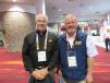 Alan Johnson (L), area sales manager of Howell Tractor & Equipment, and Mike Morton, president of Howell Tractor & Equipment, head in to see the Sennebogen booth. 