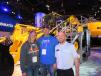 At the Komatsu booth in front of the Komatsu WA 480 wheel loader are Katie and Jay Rickert, owners of Rickert Excavating, Glenco, Minn., and Justin Sailer, district manager of Komatsu America Corp. 