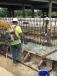Workmen pour concrete for the footing of a barrier being constructed between the I-10 eastbound mainline and the I-10 eastbound service road near the LA 108 interchange in Calcasieu Parish. 