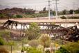 A 150-ft. portion of a century-old bridge was demolished as part of the cleanup process after the bridge was damaged in a train derailment and fire in the city of Tempe and many partners assisted Union Pacific in the demolition.