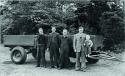 1947 - Anthony Bamford in his father's arm. (L-R) are employees Bill Hirst, Arthur Harrison and Bert Holmes.