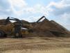 A John Deere 410E articulated dump truck receives another load of the materials being stockpiled on site.
