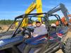 Cruising around the auction site in their Polaris RZR XP are Doug Cameron (L),  CamCorp Excavation, and his co-pilot, Charlie Thurlow, also of CamCorp in Brunswick, Maine.