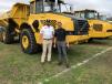 Greg Zuiderveen (L) of Jeff Martin Auctioneers speaks with Gavrie Whitlock of Nasser Heavy Equipment, Lawrenceville, Ga., about these Volvo trucks. 
