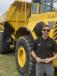 Gavin Whitlock of Nasser Equipment in the Atlanta. Ga., area takes a moment for a photo after inspecting a Volvo A350. 