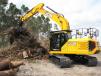 The JCB 220X LC excavator equipped with a Pemberton rotating grapple works extremely well for loading the grinder. 