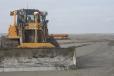 A bulldozer pushes dredged sediment around the nearby Chenier Ronquille, La., barrier island restoration project in 2017.
(NOAA Fisheries photo) 