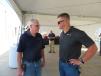 Larry Savage (L) and McCann Industries’ Ryan Carr go over some of the specs of the machines presented. 