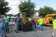 Guests gather around JCB equipment during the open house. 