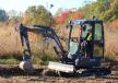 The L25 Electric compact wheel loader is being used to haul and lay down gravel for a wheelchair-accessible half-mile trail around a pond and to clear brush. 