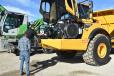 Ken Romeo shows the ease of service and essential maintenance points from the ground for the Volvo A45G articulated hauler to this potential customer. 