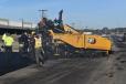 A Caterpillar AP 1055F lays down a coat of asphalt at the new Amazon facility in Syosset, N.Y.
(CEG photo)