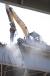 With concrete hanging onto tendons of rebar and water spray twinkling in the sun, this Cat excavator painstakingly chisels away at one of a dozen bridges to be removed.
(Dick Rohland for CEG photo)
