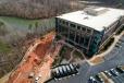 The MSE wall was directly below an occupied modern, five-story glass office building in Fort Mill, S.C. UMA and its engineers had to revise plans three times during construction and work near the wall when it unexpectedly started rapidly failing.  (UMA Geotechnical Construction Inc. photo)