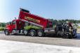 An American Pavement Specialist truck dumps asphalt into the new Raised on Blacktop 9-ton hopper of the 8520B paver.
(CEG photo)