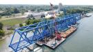 American Bridge assembled the 700-ft. blue steel structure on four jumbo barges at the Paducah Riverport. The truss was floated 14 mi. upstream on the Ohio River to the construction site near the mouth of the Cumberland River in Livingston County.
(Kentucky Transportation Cabinet photo) 