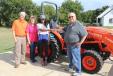 U.S. Army veteran Joy Hughes receives the keys to her new L02 Series compact tractor from her local dealer, Stewart Martin Equipment of Okmulgee, Okla.  