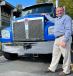 Mark Buckner, Kenworth section manager for battery electric vehicle development, stands next to a Kenworth T880.
(Photo courtesy of Kenworth) 