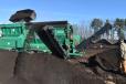 As the wheel loader delivers unprocessed material into the 4-yard hopper (top left corner) high quality, organic food waste mulch ready for bagging is stacked.
(CEG photo) 
